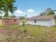Expansive backyard features a patio set and mature trees, perfect for outdoor gatherings at 16 E Orange Street St, Davenport, FL 33837