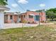 Large backyard featuring a patio, mature trees, and a lush green lawn at 16 E Orange Street St, Davenport, FL 33837
