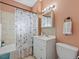 Updated bathroom featuring a vanity, mirror, and shower with decorative curtain at 16 E Orange Street St, Davenport, FL 33837