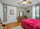 Comfortable bedroom with hardwood floors, a decorative mirror, and natural lighting at 16 E Orange Street St, Davenport, FL 33837