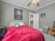 Comfortable bedroom features hardwood floors, a cozy bed, and decoratively painted walls at 16 E Orange Street St, Davenport, FL 33837