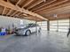 Garage with exposed wooden beams and natural light, perfect for storage and workshop activities at 16 E Orange Street St, Davenport, FL 33837