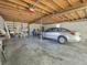Spacious garage featuring a car and exposed wooden beams, offering ample storage and parking at 16 E Orange Street St, Davenport, FL 33837
