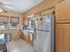 Efficient kitchen with stainless steel refrigerator, double sink, and wood cabinets for ample storage at 16 E Orange Street St, Davenport, FL 33837