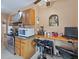 Functional kitchen featuring a computer desk, stainless steel appliances, and tiled floors at 16 E Orange Street St, Davenport, FL 33837