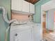 Efficient laundry room with washer, dryer, and overhead storage for added convenience at 16 E Orange Street St, Davenport, FL 33837