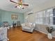 Bright living room featuring hardwood floors, a comfortable armchair, and plenty of natural light at 16 E Orange Street St, Davenport, FL 33837