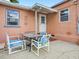 Charming outdoor patio area with seating, perfect for relaxing or entertaining guests at 16 E Orange Street St, Davenport, FL 33837