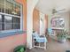 Relaxing porch featuring cushioned chairs, a ceiling fan, and an arched doorway at 16 E Orange Street St, Davenport, FL 33837