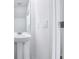 Bright powder room featuring a pedestal sink, large mirror, and crisp white walls at 16395 Bird Of Paradise Ave, Clermont, FL 34714