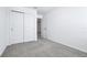 Bright bedroom features plush carpeting and closet with paneled doors at 16395 Bird Of Paradise Ave, Clermont, FL 34714