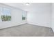 Bright bedroom with neutral carpet and two windows allowing natural light at 16395 Bird Of Paradise Ave, Clermont, FL 34714