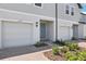 Townhome exterior features garage, front door, manicured landscaping, and neutral color scheme at 16395 Bird Of Paradise Ave, Clermont, FL 34714