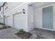 Charming townhome exterior with garage, front door, manicured landscaping, and neutral color scheme at 16395 Bird Of Paradise Ave, Clermont, FL 34714