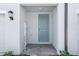 Close up view of a charming entryway with a neutral colored front door at 16395 Bird Of Paradise Ave, Clermont, FL 34714