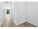 Hallway with wood floors and white walls at 16395 Bird Of Paradise Ave, Clermont, FL 34714
