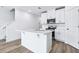 Bright kitchen features a center island, stainless appliances, and crisp white cabinets at 16395 Bird Of Paradise Ave, Clermont, FL 34714