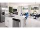 Open kitchen and living space featuring stainless steel appliances, granite counters, tile floors, and lots of natural light at 16395 Bird Of Paradise Ave, Clermont, FL 34714