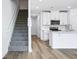 Open kitchen features white cabinets, a kitchen island, and stainless appliances at 16395 Bird Of Paradise Ave, Clermont, FL 34714