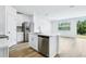 Kitchen with stainless appliances, a kitchen island with a stainless dishwasher and white cabinetry at 16395 Bird Of Paradise Ave, Clermont, FL 34714
