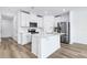 Kitchen with white cabinets, a kitchen island, stainless appliances, and a white subway tile backsplash at 16395 Bird Of Paradise Ave, Clermont, FL 34714