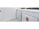 Laundry room with modern white washer and dryer at 16395 Bird Of Paradise Ave, Clermont, FL 34714