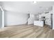 Bright, open living area featuring stylish wood floors that lead to the kitchen at 16395 Bird Of Paradise Ave, Clermont, FL 34714