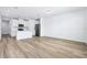Bright living room features wood floors, an open concept and a modern kitchen with stainless appliances at 16395 Bird Of Paradise Ave, Clermont, FL 34714
