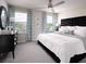 Serene bedroom with plush bedding, ceiling fan, lots of natural light, and stylish decor at 16395 Bird Of Paradise Ave, Clermont, FL 34714