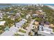 Aerial view of a coastal neighborhood with lush greenery and homes leading up to the ocean and beach at 1640 N Atlantic Ave, New Smyrna Beach, FL 32169