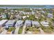Stunning aerial view of beach houses, lush greenery, and serene waterfront creates a coastal living paradise at 1640 N Atlantic Ave, New Smyrna Beach, FL 32169
