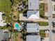 Overhead aerial view showcasing multiple homes with pools, manicured lawns, and driveways at 1640 N Atlantic Ave, New Smyrna Beach, FL 32169