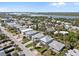 An aerial view showing a neighborhood near a river and ocean, featuring a mix of houses and lush greenery at 1640 N Atlantic Ave, New Smyrna Beach, FL 32169