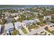 Aerial shot of a neighborhood with a mix of houses and lush greenery, nestled near a tranquil body of water at 1640 N Atlantic Ave, New Smyrna Beach, FL 32169