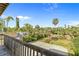 Deck overlooking lush green tropical backyard with mature landscaping and privacy fence at 1640 N Atlantic Ave, New Smyrna Beach, FL 32169