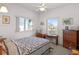 Bedroom featuring two windows, a writing desk, dresser, and a patterned quilt at 1640 N Atlantic Ave, New Smyrna Beach, FL 32169