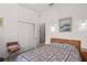 Bedroom featuring a bed with a patterned quilt and built-in storage above it at 1640 N Atlantic Ave, New Smyrna Beach, FL 32169