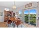 Bright dining room with wood floors, a chandelier, china cabinet and access to the porch at 1640 N Atlantic Ave, New Smyrna Beach, FL 32169