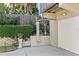 Driveway with mature hedges, and flowers along a side wall, leading to a single-car garage at 1640 N Atlantic Ave, New Smyrna Beach, FL 32169