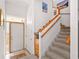 Inviting foyer with tiled floors, a staircase with wooden handrails, and a white front door at 1640 N Atlantic Ave, New Smyrna Beach, FL 32169