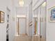 Bright entryway with mirrored closet doors, neutral walls, and modern lighting features for a welcoming entrance at 1640 N Atlantic Ave, New Smyrna Beach, FL 32169