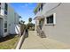 Side view of a home featuring a small porch leading to the front door at 1640 N Atlantic Ave, New Smyrna Beach, FL 32169