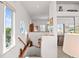 Bright hallway with a decorative stained glass window, wooden accents, and a view into a cozy living space at 1640 N Atlantic Ave, New Smyrna Beach, FL 32169