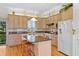 Bright kitchen featuring custom cabinets, an island with bar stool seating and stainless appliances at 1640 N Atlantic Ave, New Smyrna Beach, FL 32169
