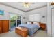 Sun-filled bedroom with a sliding glass door to a private balcony and light carpeted floors at 1640 N Atlantic Ave, New Smyrna Beach, FL 32169