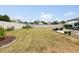 Spacious backyard features lush green grass, a privacy fence, and a patio area for relaxing at 17500 Butterfly Pea Ct, Clermont, FL 34714