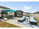 Wide angle shot of backyard featuring patio, outdoor furniture, and screened lanai at 17500 Butterfly Pea Ct, Clermont, FL 34714