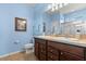 Bathroom featuring double sinks, a separate toilet, and a glass enclosed shower stall at 17500 Butterfly Pea Ct, Clermont, FL 34714