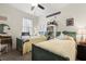 A bedroom featuring two twin beds, a ceiling fan, and natural lighting at 17500 Butterfly Pea Ct, Clermont, FL 34714