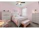 A pink bedroom featuring a bed with floral bedding and a decorative vanity at 17500 Butterfly Pea Ct, Clermont, FL 34714